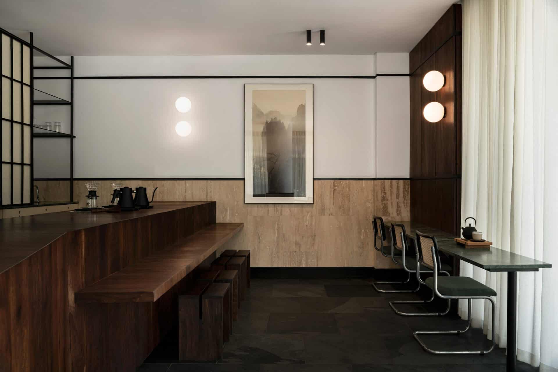 Interior of Rosetta Roastery Claremont with travertine walls and a dark timber counter
