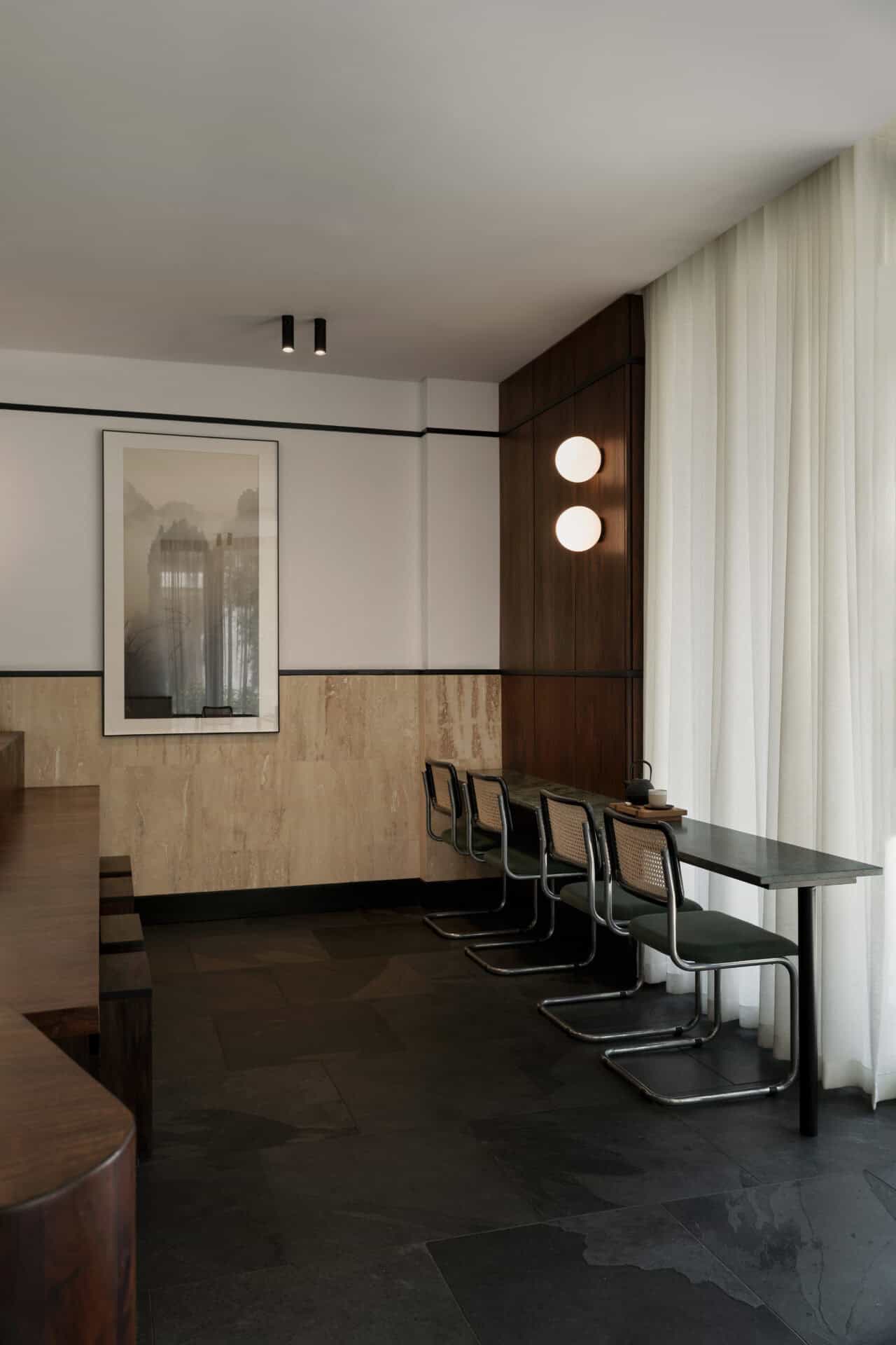 Bench seating and cane chairs along the window at Rosetta Roastery Claremont