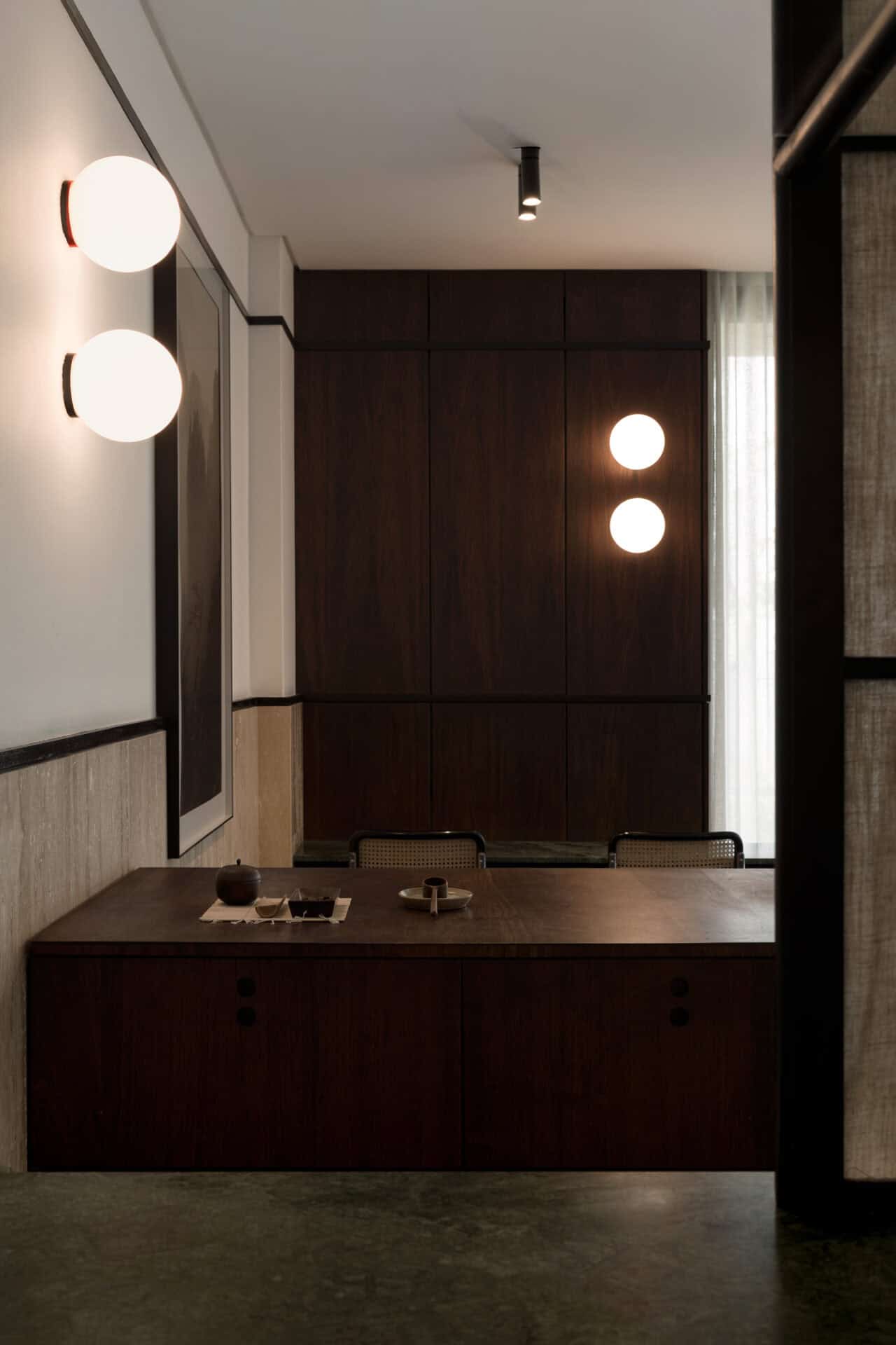 Timber service counter and paired globe wall lights at Rosetta Roastery