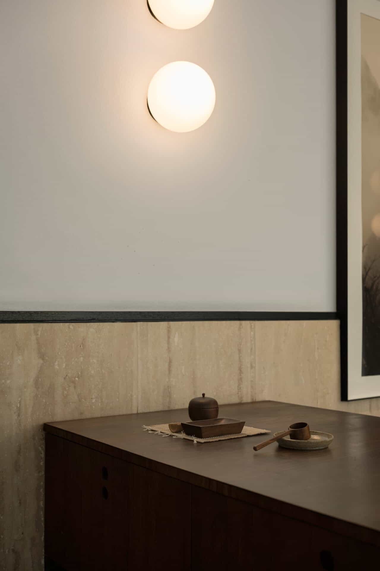 Globe light above the travertine and timber counter at Rosetta Roastery