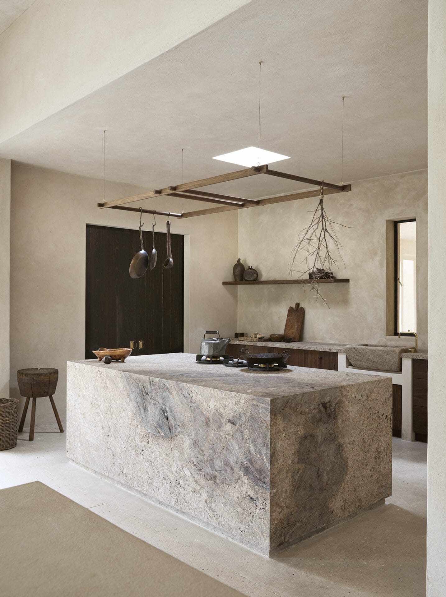 Kitchen at Mura built around a monolithic stone island