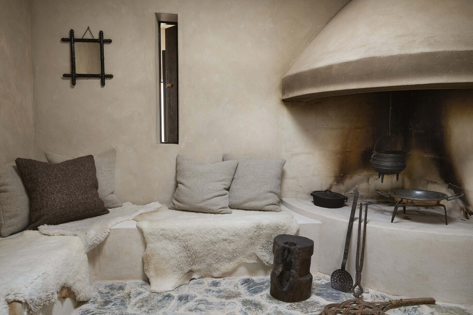 Inglenook fireplace at Mura with a plastered hood and built-in cushioned seating