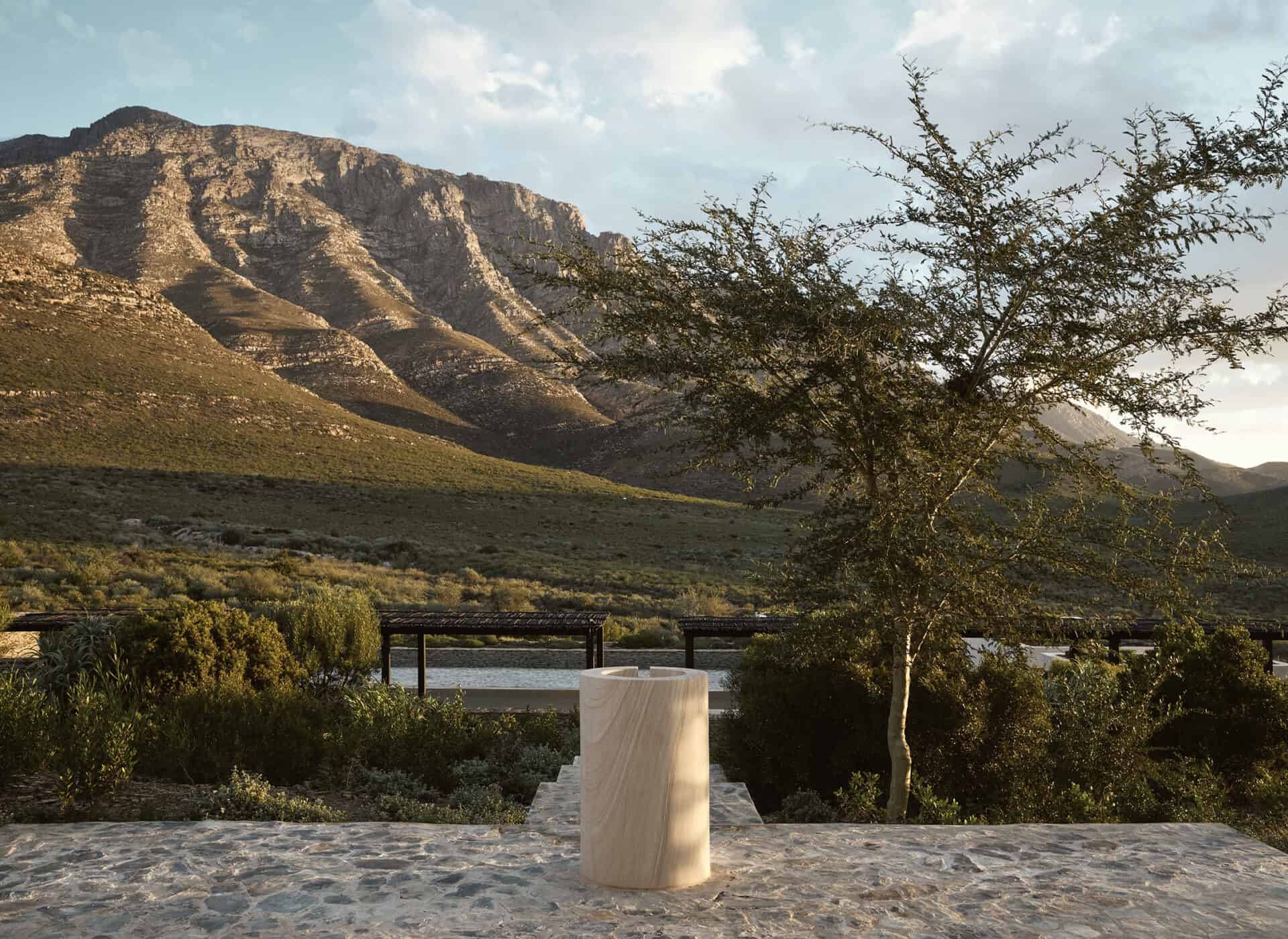 Carved stone plinth set against the mountains at Mura
