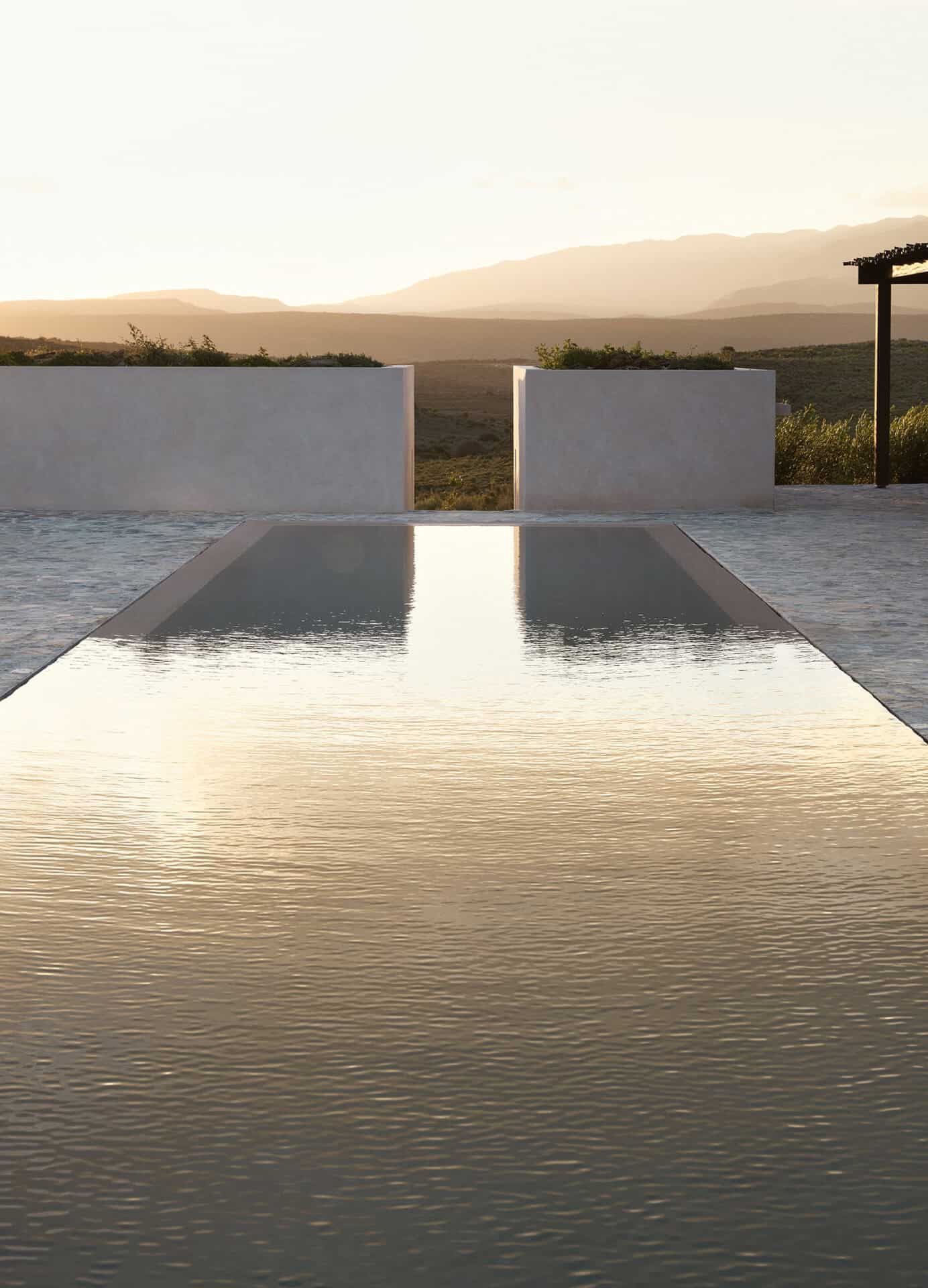 Infinity pool at Mura reflecting the last light over the Klein Karoo