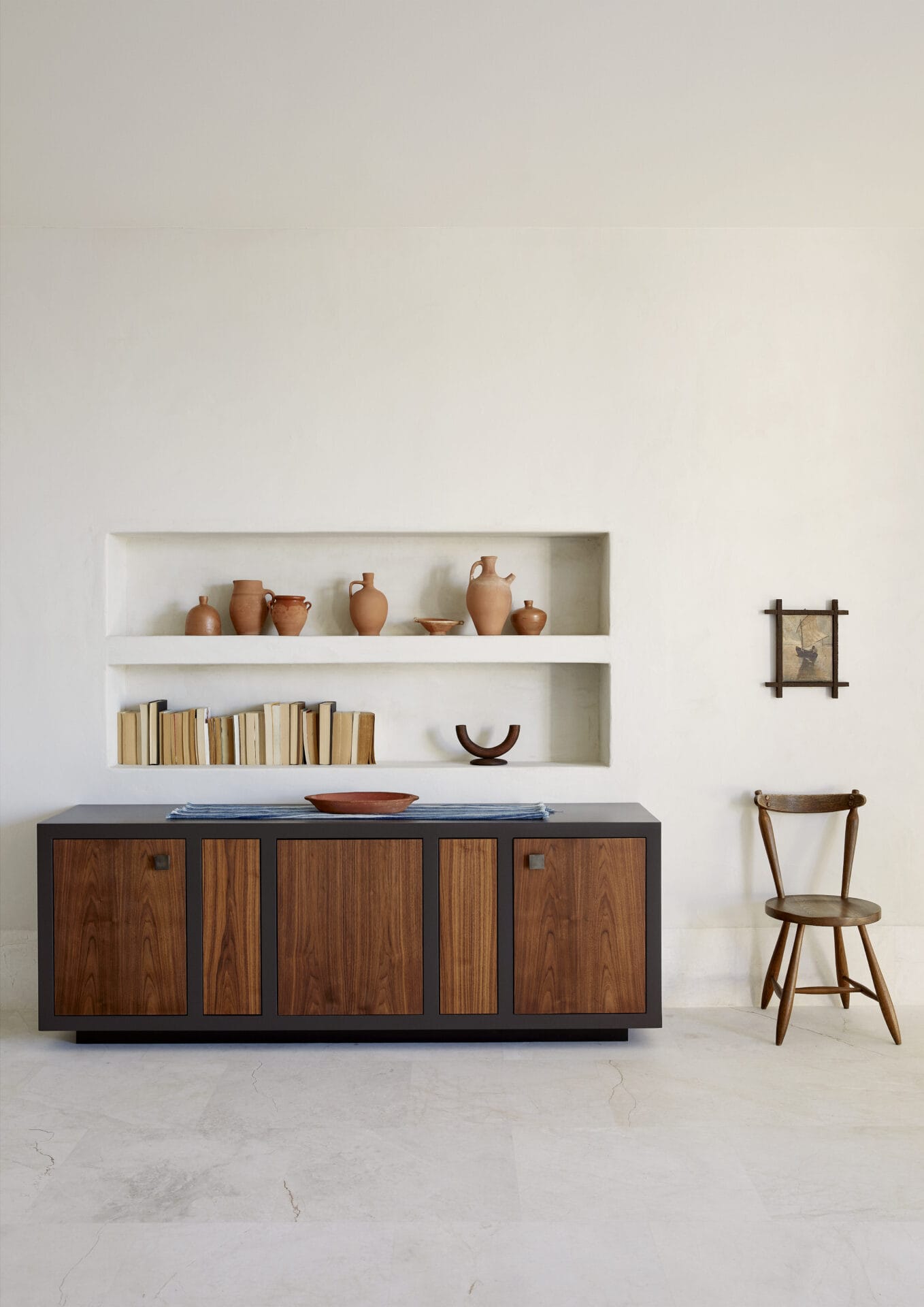 Timber sideboard and open shelving holding ceramics at House T
