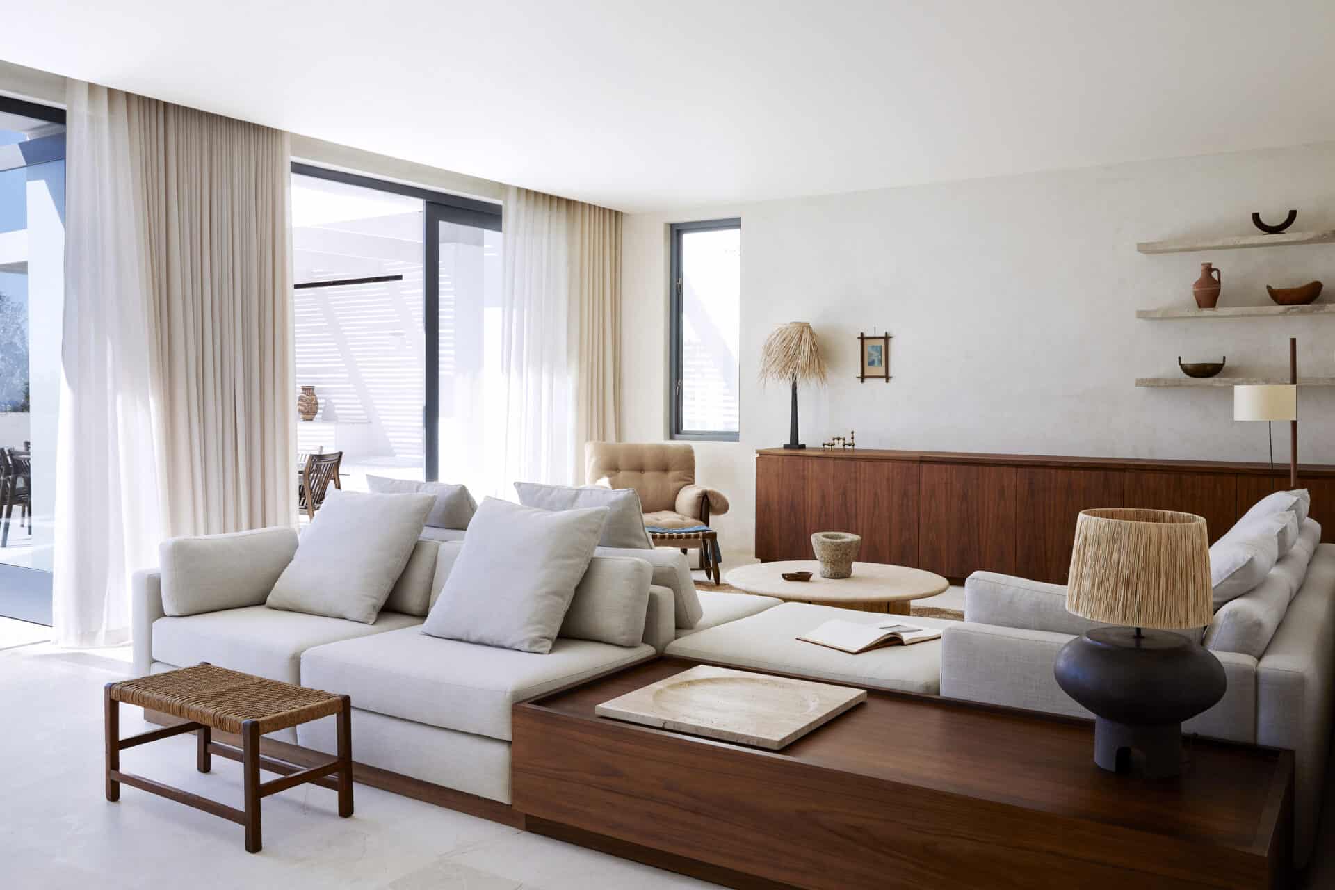 Living room at House T with deep linen sofas and a timber bar facing the Atlantic